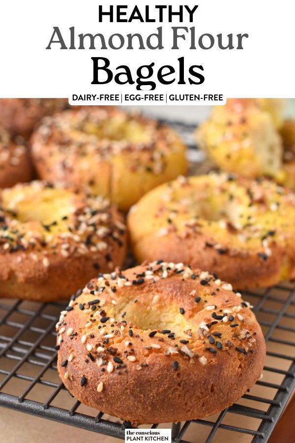 baked bagels with poppy seed sprinkles on a cooling rack and text overlay that reads healthy almond flour bagels