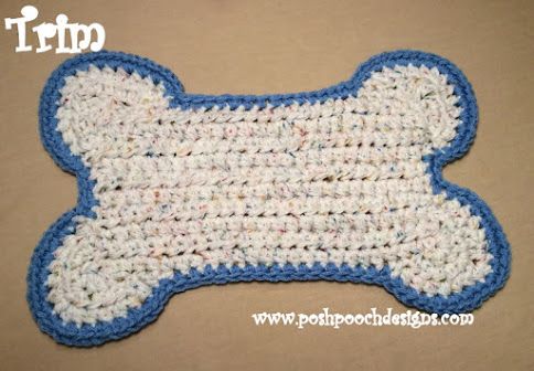 a crocheted dog bone with blue trim