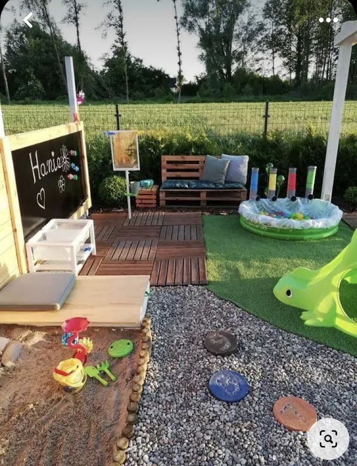 an outdoor play area with toys and sand