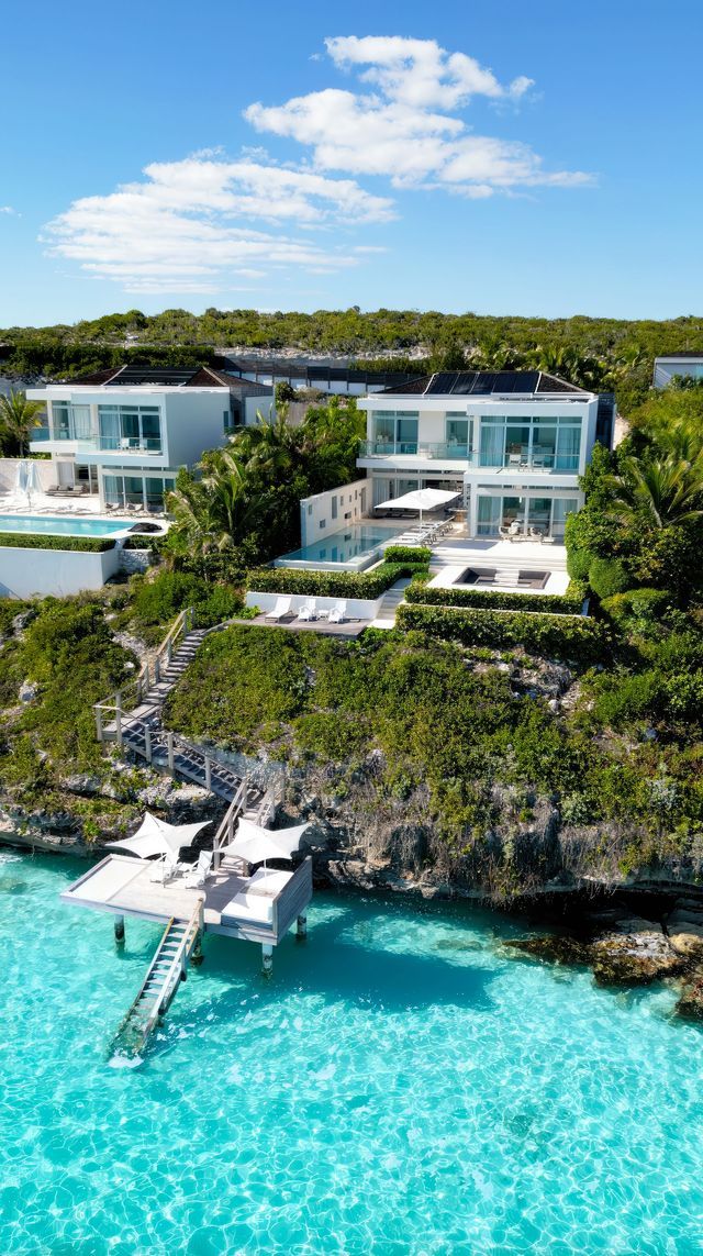 an aerial view of a house on the water