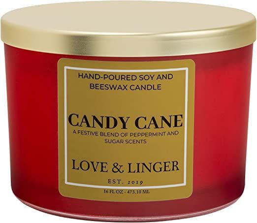 a candle that is red and yellow with the words candy cane on it's lid