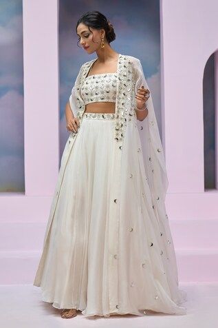 Ivory cape with mirror and nalki embroidery. Comes with coordinating blouse and embroidered waistband lehenga. - Aza Fashions Wedding Sets With Cutdana And Cape Sleeves, White Embroidered Dress With Cape Sleeves, Festive White Dress With Cape Sleeves, White Fitted Set With Cape Sleeves, Embroidered Choli With Cape Sleeves For Wedding, Cape Sleeve Choli With Mirror Work For Reception, Reception Choli With Mirror Work And Cape Sleeves, White Sets With Dupatta And Cape Sleeves, Festive White Sets With Cape Sleeves