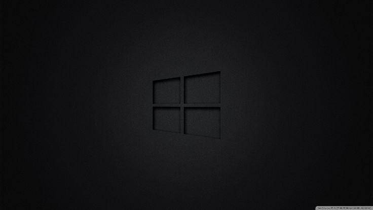 a black wall with the windows logo on it's left side and an empty window in the middle