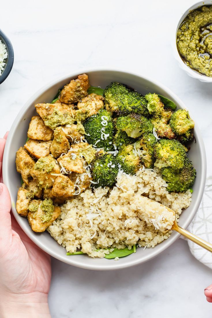 a bowl filled with rice, broccoli and tofu