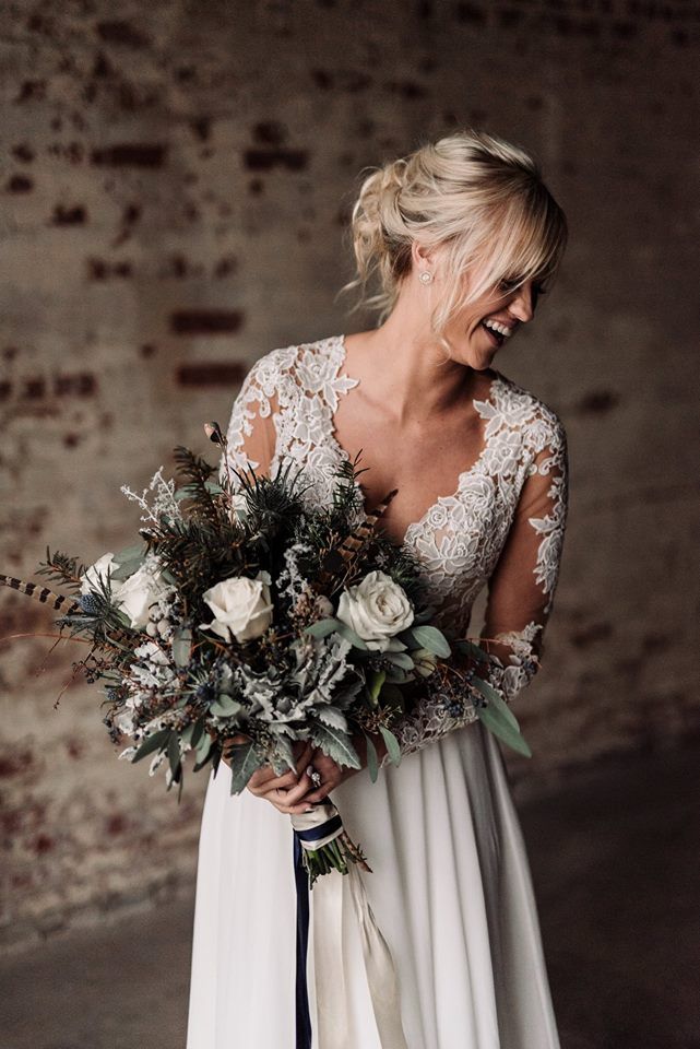 a woman in a white dress holding a bouquet