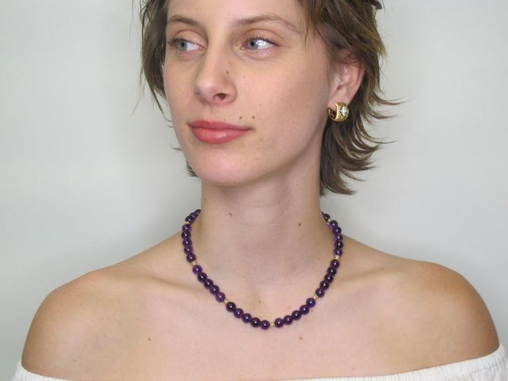 This richly colored amethyst bead necklace features gorgeous 8.25mm round amethyst beads that have been hand strung with delicate white seed pearls and 18k yellow gold beaded spacers. This combination of royal purple, gold, and pearls allow this necklace to look casual or dressy, depending on what you choose to wear it with! Finished with a 14k yellow gold high-polished ball clasp, this is sure to be one of your new favorites!Necklace measures 16.5 inches in length Elegant Single Strand Amethyst Beaded Necklace, Elegant Purple Round Beaded Necklaces, Purple Amethyst Pearl Necklace With Gemstone Beads, Purple Amethyst Gemstone Beads Pearl Necklace, Elegant Purple Beaded Necklace With Round Beads, Classic Purple Round Bead Jewelry, Purple Round Bead Necklace For Formal Occasions, Formal Purple Necklaces With Round Beads, Formal Purple Beaded Necklaces