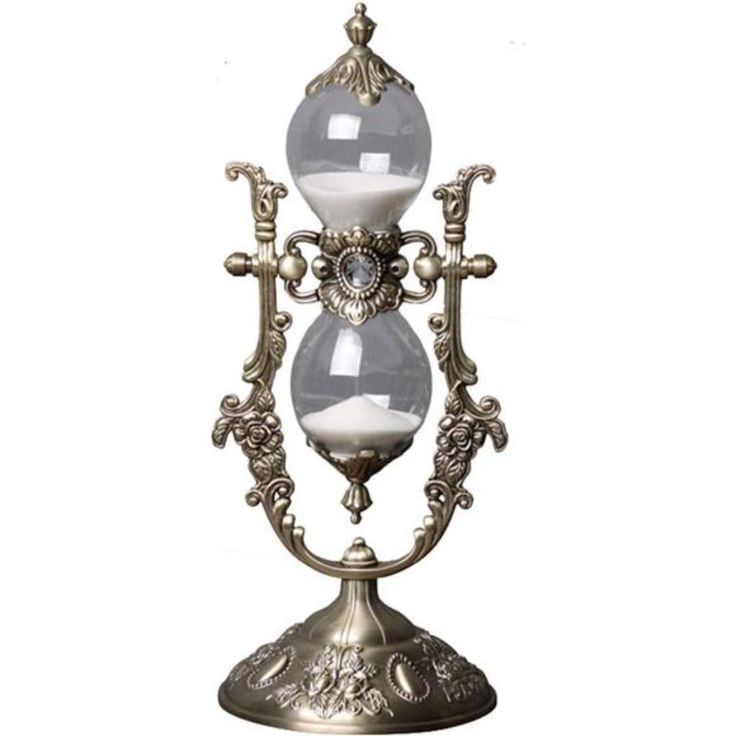 an ornate metal candle holder with two glass globes on it's sides,