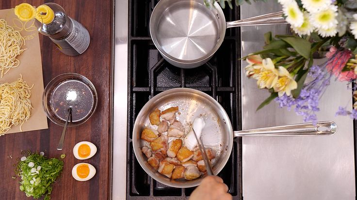 a person cooking food on top of a stove