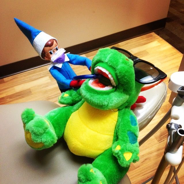 a green stuffed animal sitting on top of a table