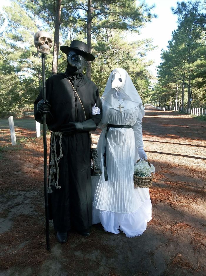 a man and woman dressed in costume standing next to each other