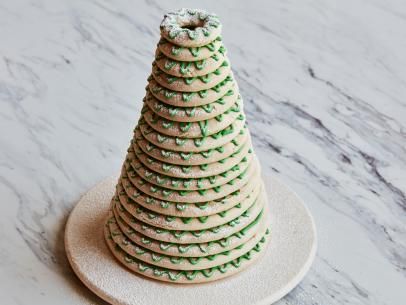 a stack of cookies with green sprinkles sitting on top of a white plate