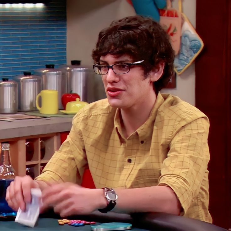 a man sitting at a table with cards in front of him