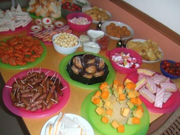 a table topped with lots of different types of food and desserts on top of plates