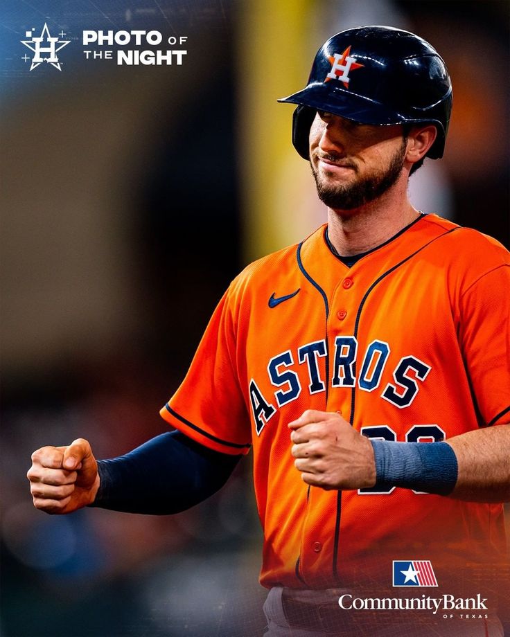 a professional baseball player is smiling and holding his arm in the air while wearing an orange uniform