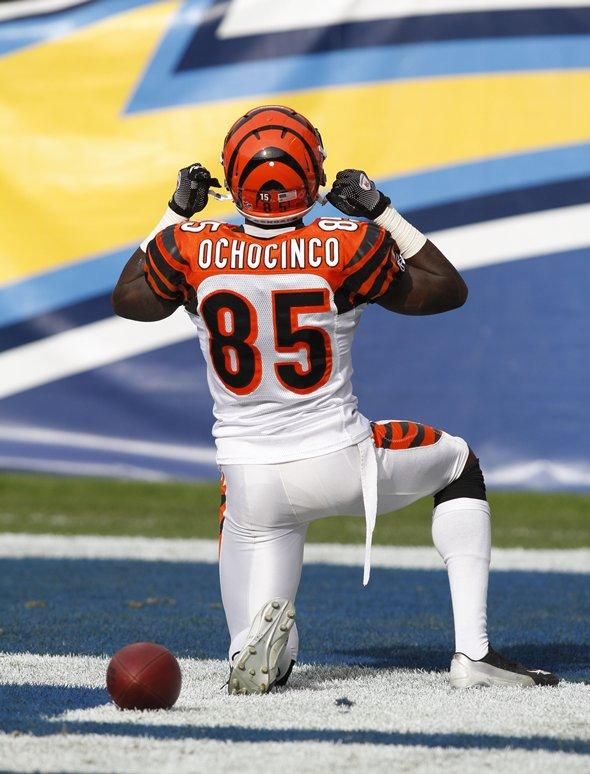 a football player sitting on the ground with his foot up