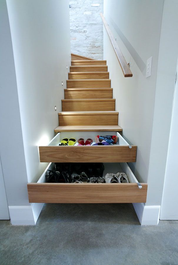 there is a drawer under the stairs with shoes in it