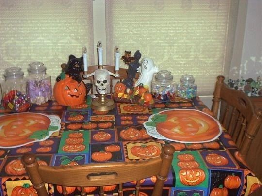 a dining room table covered in halloween decorations