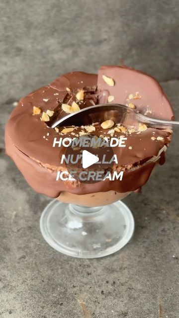 an ice cream sundae with chocolate frosting and nuts