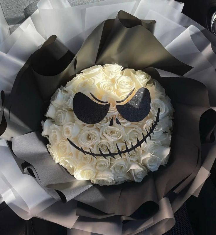 a cake decorated to look like a skeleton with roses in it's mouth and eyes