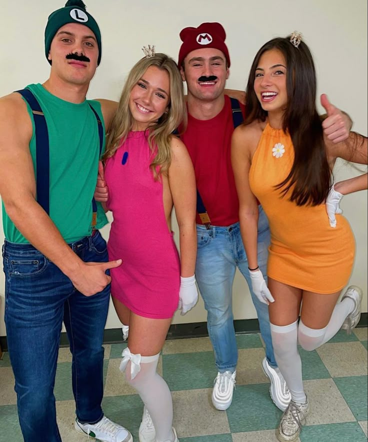 four people dressed in costumes posing for a photo with one person wearing a fake moustache