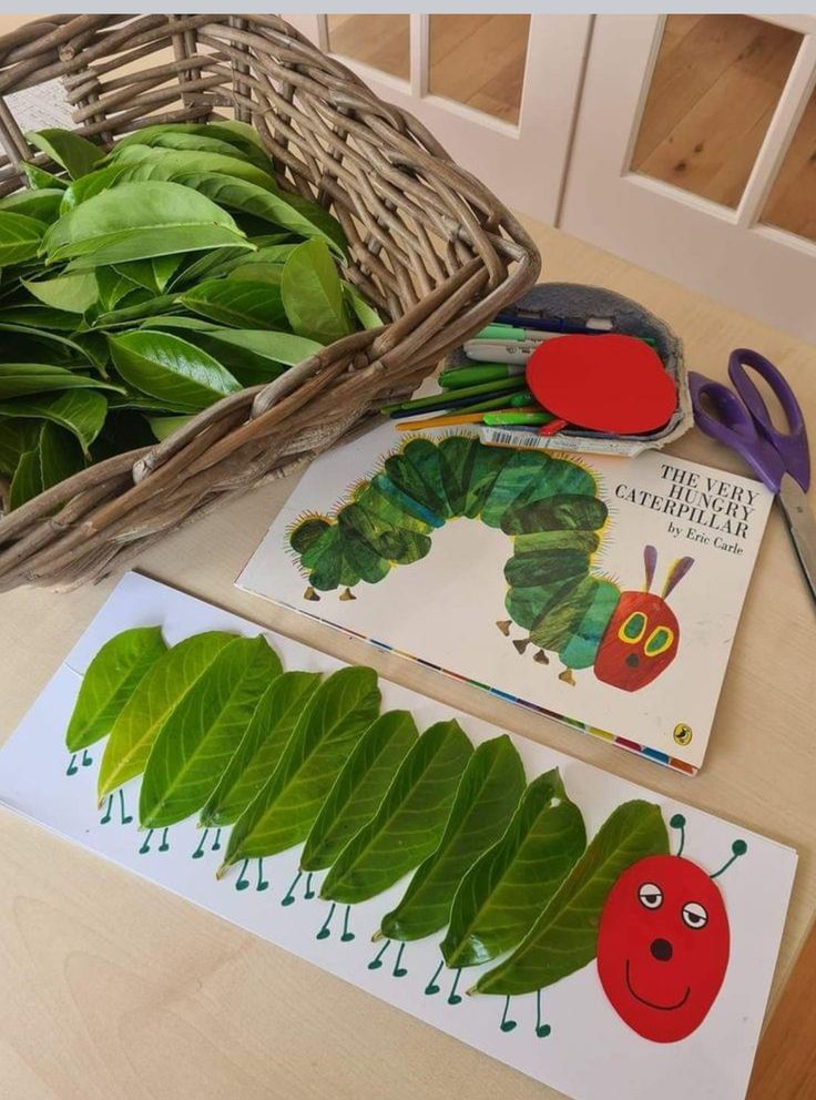 the very hungry caterpillar book and cut outs are sitting on a wooden table