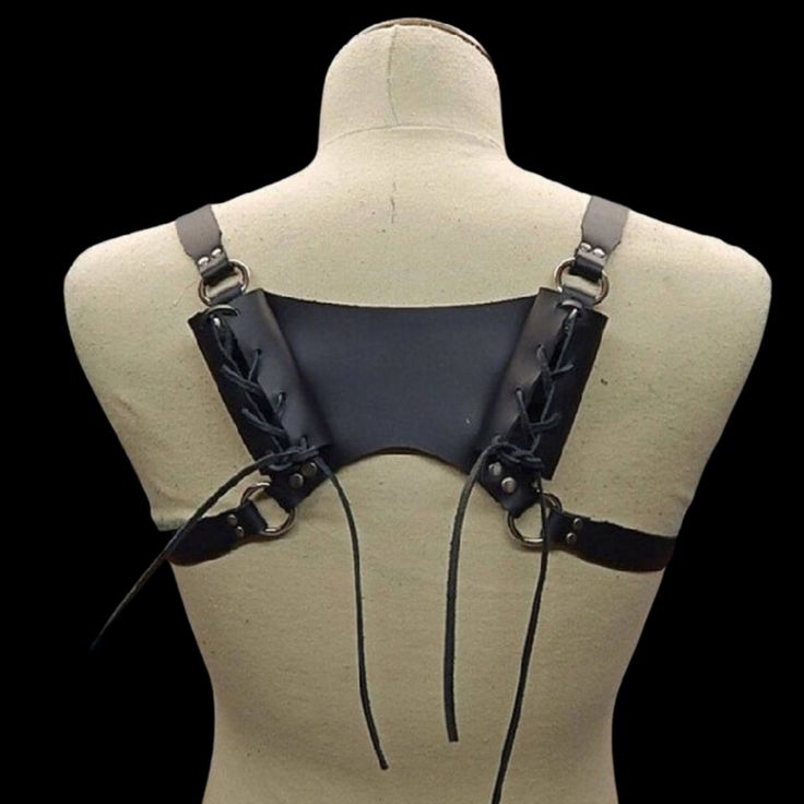 Inspired by the battle-ready gear of ancient Norse warriors, this double-sword back harness is a true masterpiece. Crafted with precision and an unwavering commitment to authenticity, it pays homage to the fearsome warriors of old while catering to the needs of contemporary enthusiasts. The harness features a rugged leather construction. The supple yet durable leather ensures your weapon is not only securely housed but also displayed with pride. The adjustable leather straps ensure a comfortable Gothic Harness For Cosplay, Gothic Strapped Harness For Cosplay, Strapped Gothic Harness For Cosplay, Adjustable Black Harness With Belt, Gothic Black Harness For Cosplay, Black Gothic Harness For Cosplay, Black Strapped Harness For Cosplay, Adjustable Strapped Harness For Cosplay, Black Gothic Harness With Belt