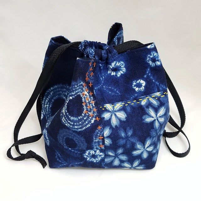 a blue bag with white flowers on it