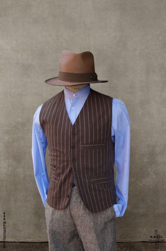 Made in soft striped cotton in dark brown color. Back panel in Belgian linen in officer olive color. Fully lined in soft cotton. Dark brown corozo buttons. We have revamped the vest of our waistcoat to be less slim. Slightly lower the armhole for more comfort. Chest pocket deeper for most phones, eyeglass case (leather eyeglass case not included). Two lower pockets plus one pocket for wrist watch. One big inside pocket. Size S: chest 38" Size M: chest 40" Size L: chest 42" Size XL: chest 44" Siz Tailored Brown Vest With Pockets, Tailored Brown Vest With Buttons, Brown Cotton Vest With Buttons, Brown Sleeveless Single-breasted Vest, Brown Single-breasted Sleeveless Vest, Tailored Single-breasted Brown Vest, Classic Brown Cotton Vest, Classic Brown Vest With Buttons, Classic Brown Vest With Pockets