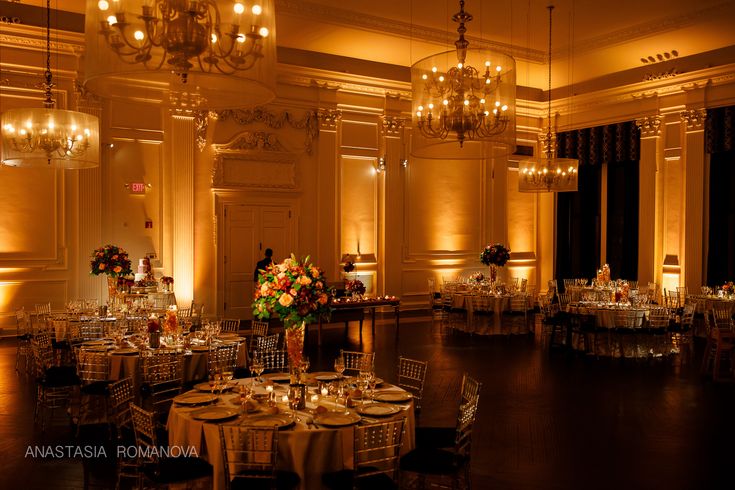 an elegant ballroom with chandeliers and tables set up for formal dinnereons