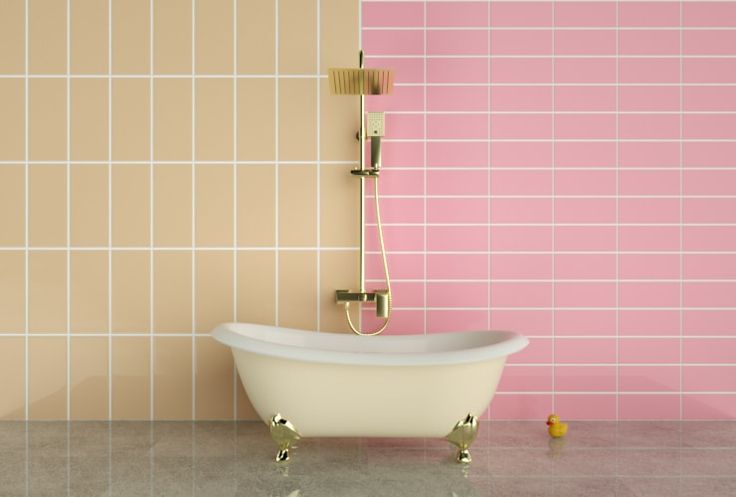 a bath tub sitting next to a pink tiled wall with gold fixtures on the side