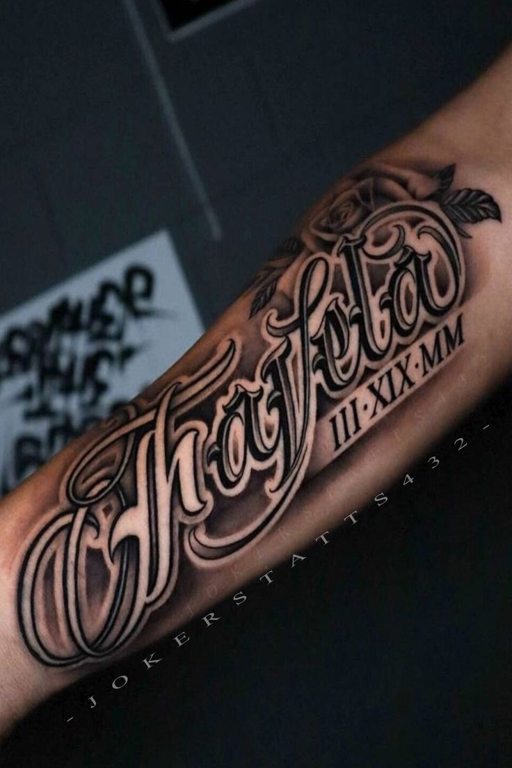 a man's arm with the word tattoo on it