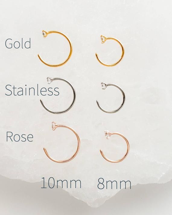 Delicate Hug Hoop Earrings with a dainty CZ accent, choose from 2 sizes!  Available in single or pairs.• T H E • D E T A I L S • • Available in Surgical steel, Gold plated Surgical steel or Rose gold plated Surgical steel • Hoop wire measures 20g • CZ measures 2.5mm• Two sizes: 8mm and 10mm• Thoughtfully packaged & ready for gift giving!• Handmade, just for you, in our sunny California Studio• Our 365 Guarantee: Our jewelry is guaranteed for 1 year after purchase date against defects.• Your Modern Hoop Earrings, Rose Gold Circle, Knot Studs, Coin Bracelet, Dragonfly Earrings, Tiny Stud Earrings, Gold Bracelet Chain, Delicate Earrings, Everyday Earrings