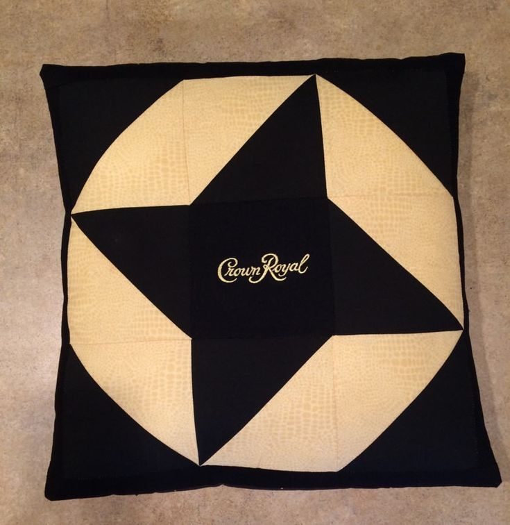 a black and white quilted pillow with the word crown royal on it