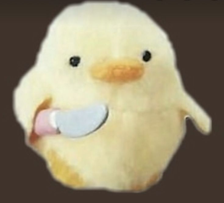 a stuffed duck with a pacifier in it's mouth and tongue sticking out