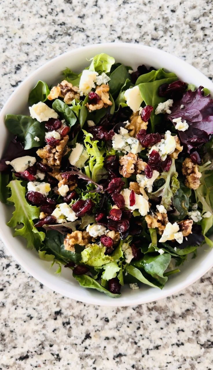 a white bowl filled with salad on top of a table