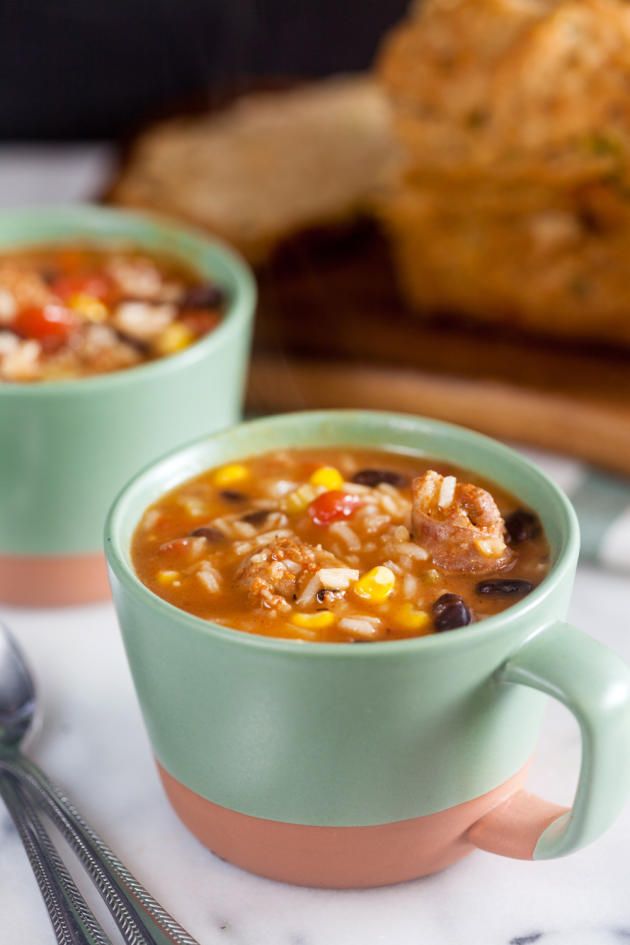 two green cups filled with soup on top of a table