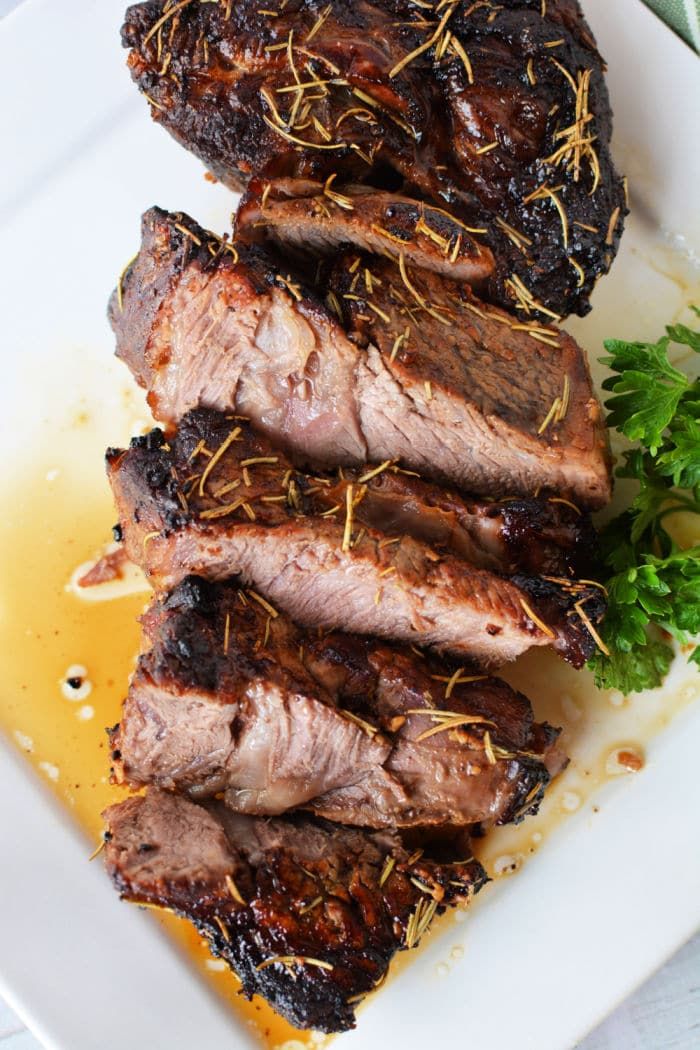 grilled meat sitting on top of a white plate