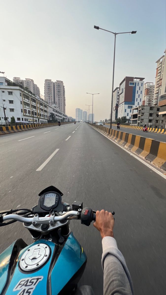 a person riding a motorcycle on a city street