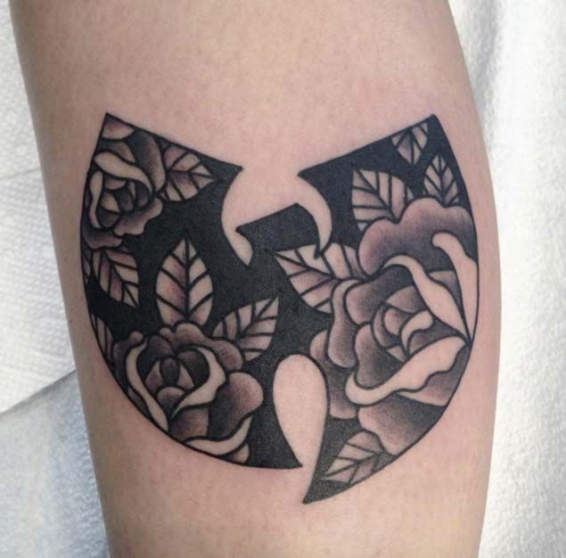 a black and white tattoo with roses on it