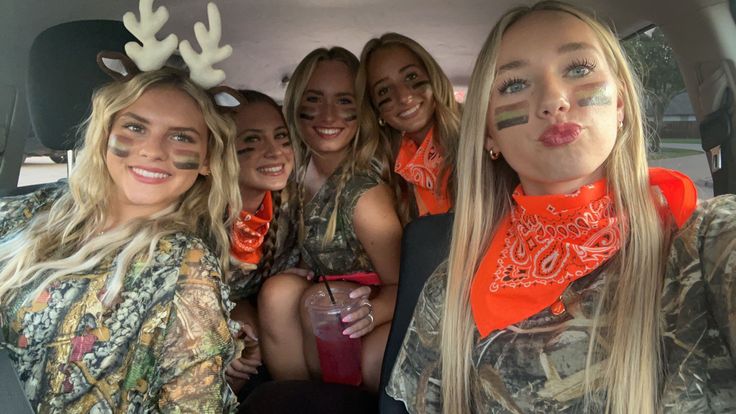 a group of women in camo outfits posing for a photo with fake antlers on their faces