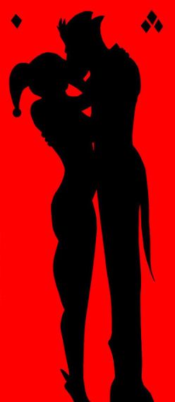 a couple kissing in silhouette against a red background