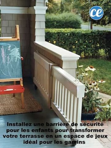 an easel sitting on top of a porch next to a flower bed and potted plant