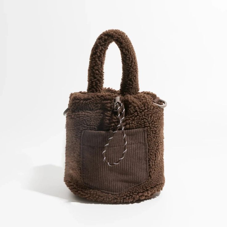 Embrace casual, comfy, and cozy style with the Teddy Pocket Bucket Bag. Crafted with soft-touch material, this bag features an extra detachable and adjustable strap, a corduroy pocket at the front, and adjustable drawstring closures. Perfect for a laid-back yet stylish look. Soft touch material Extra detachable & adjutable strap Corduroy pocket at front Adjustable drawstring closures Size: length 18cm (7.1inc) width 16cm (6.3inc) height 20cm (7.8inc) Strap size: height 12cm (4.7inc) Brown Contact Lenses, Green Contacts Lenses, Purple Contacts, Y2k Necklace, Baby Tees Y2k, Streetwear Grunge, Y2k Baby Tee, Cozy Style, Corsets And Bustiers