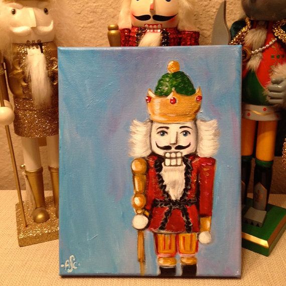 a painting of a nutcracker on a canvas next to other toy figurines