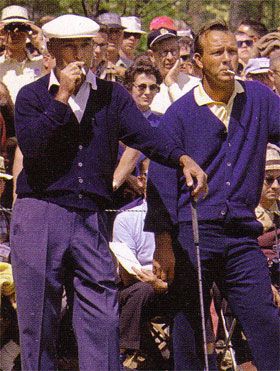 two men in purple suits and white hats are holding golf clubs while an audience looks on