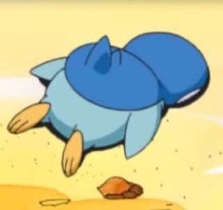 a cartoon character flying through the air on top of a sandy beach with rocks and pebbles