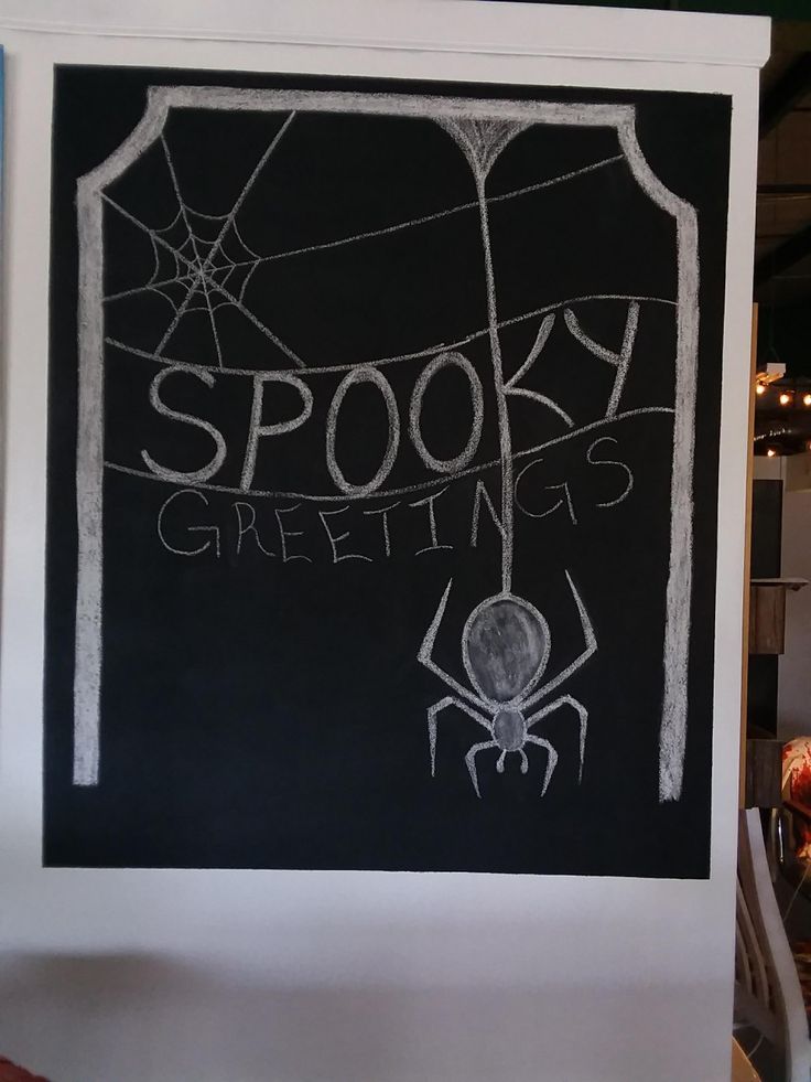 a blackboard with the words spooky greetings written on it