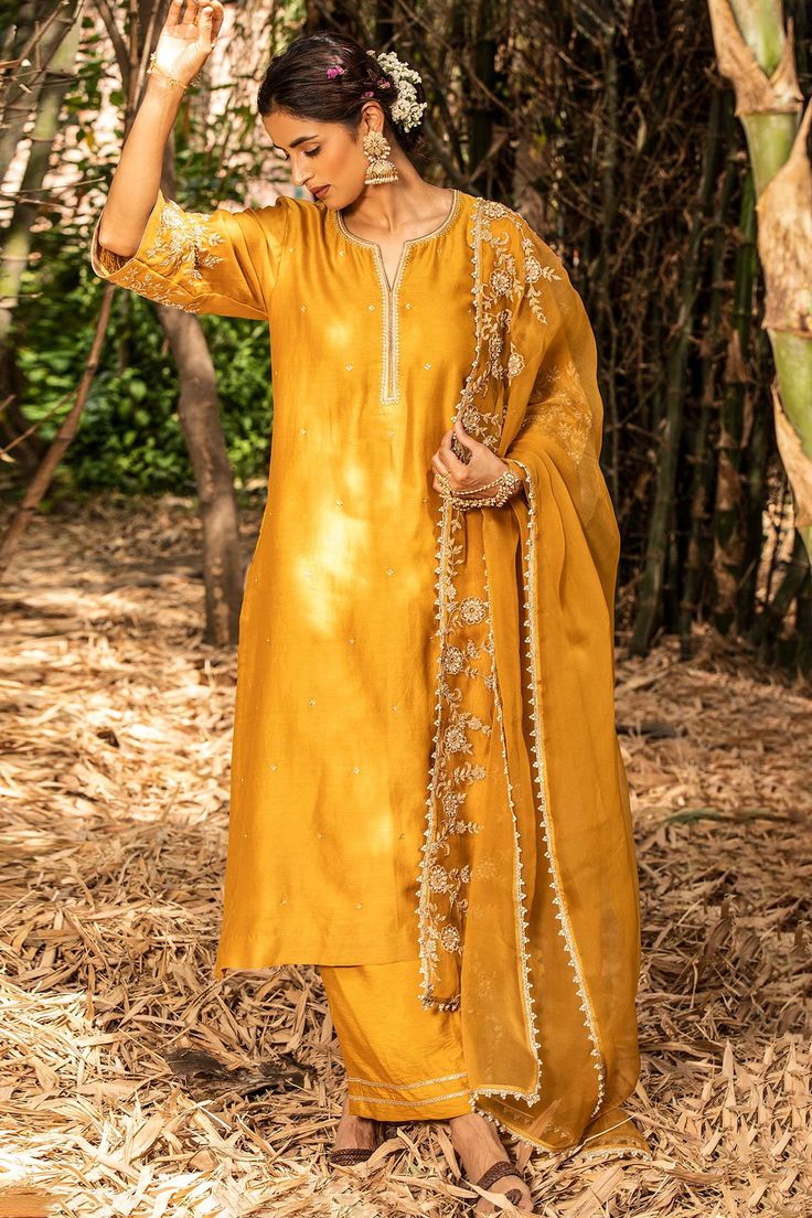 Yellow chanderi long kurta with dori pearl embroidered sleeves. Paired with floral embroidered dupatta and pant.
Component: 3
Pattern: Embroidered
Type Of Work: Floral Motifs
Neckline: Notched
Sleeve Type: Three Quarter
Fabric: Kurta: Chanderi, Pant: Cotton Silk, Dupatta: Organza Silk
Color: Yellow
Other Details: 
Floral motif embroidery
Occasion: Puja - Aza Fashions Yellow Kurta, Motif Embroidery, Long Kurta, Kurta Pant Set, Pearl Embroidery, August Wedding, Embroidered Sleeves, Embroidered Organza, Embroidered Dupatta