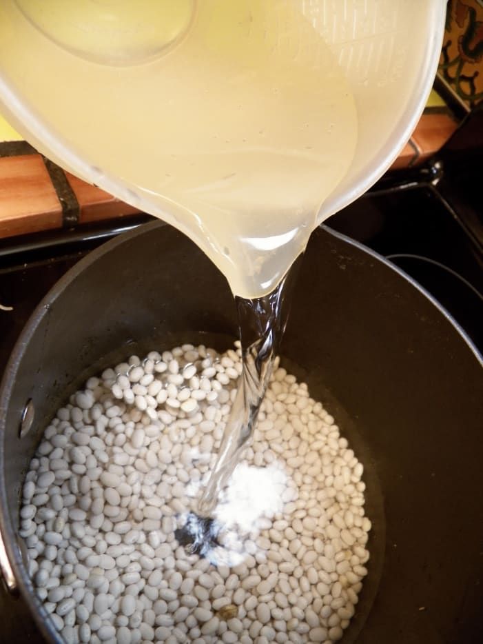 a pot filled with white liquid sitting on top of a stove