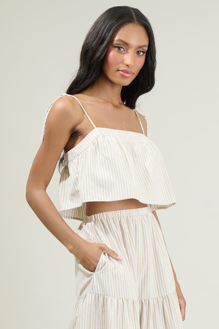 Better grab your favorite shades, 'cause the Everlanes Striped Crop Top is here to welcome in those bright sunny days! A summery striped pattern throughout, shapes self-tie spaghetti straps that support a cropped look! Wear it with the matching skirt to complete a summer look! - Stripe- Tie strap- Crop top- Lined- Color: Tan WhiteSize + Fit - Model is 5'8" and wearing size XS- Measurements taken from size S - Chest: 17 1/4"- Length: 10" Fabric Self: 50% Polyester 50% Cotton Lining: 97% Polyester Striped Crop Top For Beach In Spring, Spring Striped Crop Top For Beach, Striped Crop Top For Spring Beach Outing, Striped Crop Top For Day Out, Striped Cropped Top For Day Out, Spring Day Out Crop Top With Tie Straps, Chic Striped Crop Top For Vacation, Spring Crop Top With Tie Straps For Day Out, Cotton Crop Top With Tie Straps For Vacation